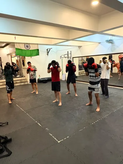 A moment from our group boxing class. Everyone is squared up, hands high, ready to drill the techniques that build sharp, effective strikers.