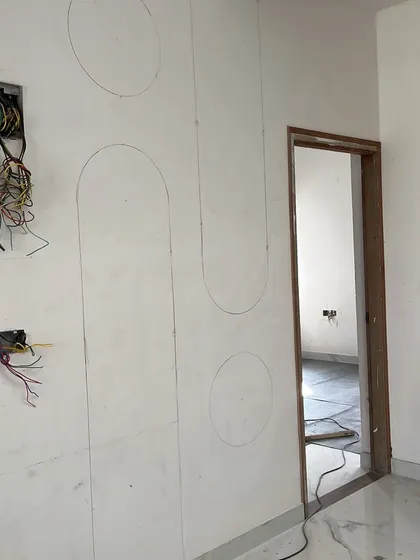 The initial pencil markings for the decorative wall panels, showing the planning and precision that precedes the final installation and painting.