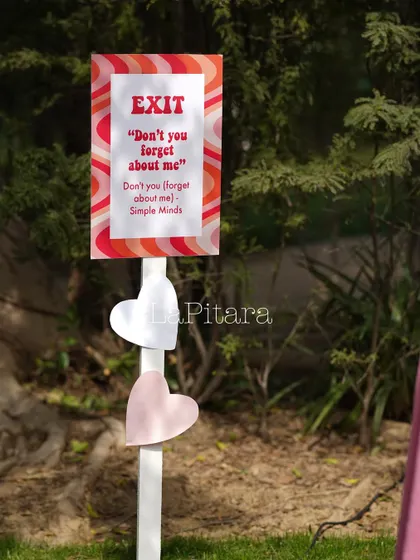 A fun exit sign with a nod to a classic 80s song, 'Don't you forget about me'.