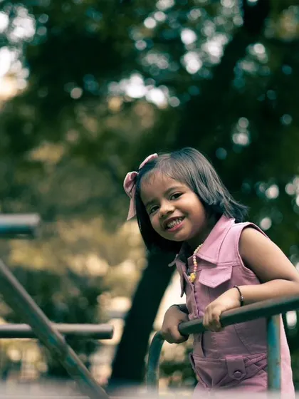 A tighter crop of a similar candid moment. The genuine smile is what makes a children's portrait truly special and timeless.