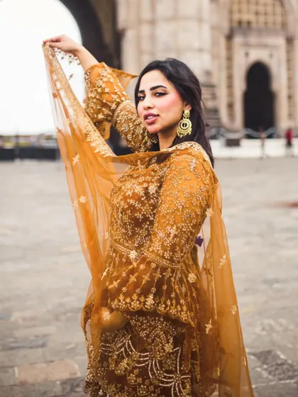 A bold and beautiful portrait in front of the Gateway of India. The way her dupatta catches the wind adds a lovely sense of movement and grace to the image.