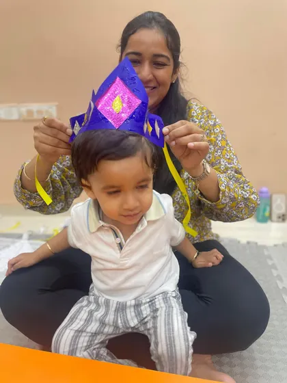 Another happy moment as a mother places a handmade crown on her child's head.