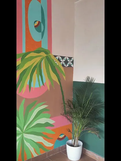 A corner view of the abstract tropical mural, showing how the design wraps around the space.
