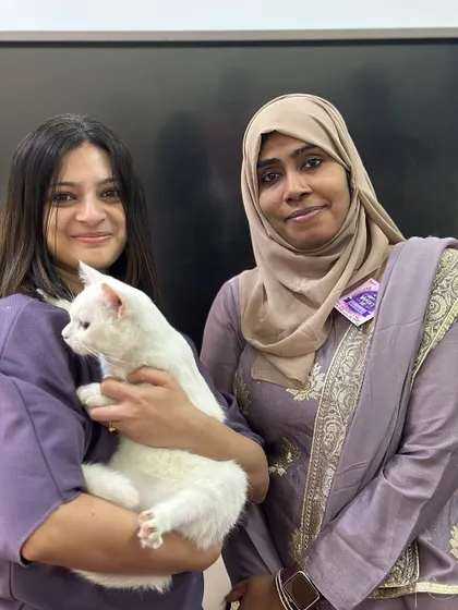 A beautiful white cat finds her new family. The rescuer and adopter share a proud moment. It's a collaborative effort between rescuers who save them and adopters who give them a future.