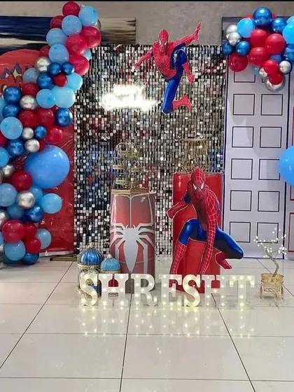 Your friendly neighborhood Spider-Man swings into the party with this action-packed theme. We use city building backdrops, a silver sequin wall, and red and blue balloons to create a superhero adventure.