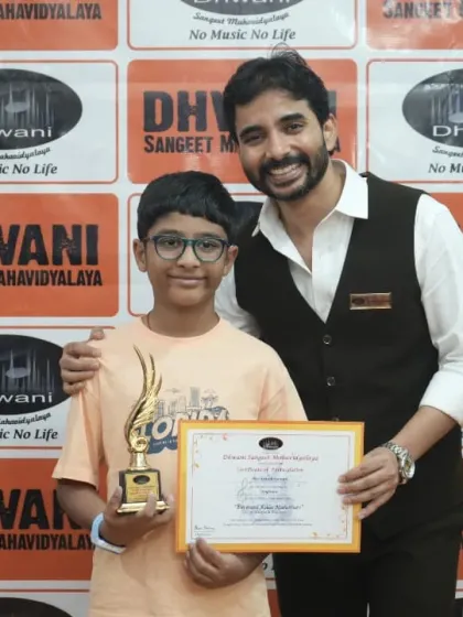 A student receives his award from his teacher, a happy and proud moment.