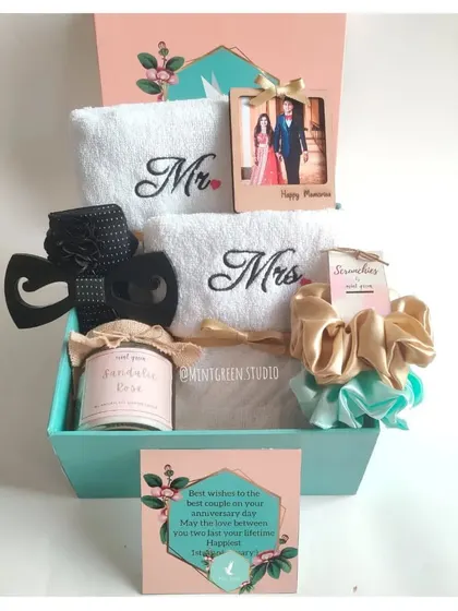 A beautiful anniversary gift box for the perfect pair. This hamper includes embroidered 'Mr' and 'Mrs' towels, a personalized photo frame, a scented candle, and matching accessories for him and her.