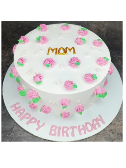 A simple floral cake for Mom's birthday. This mixed fruit cake is decorated with pretty pink rosettes.