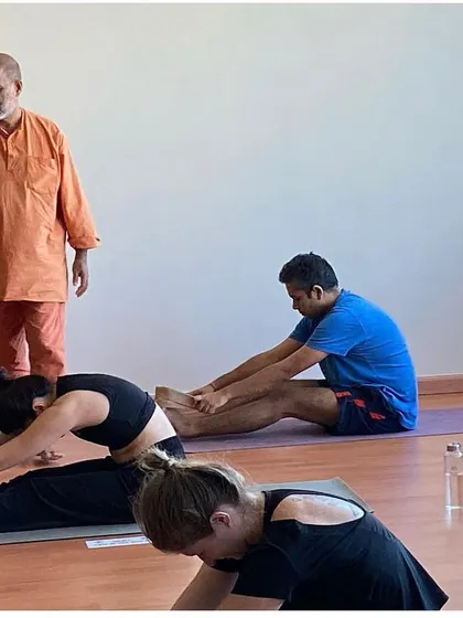 During a masterclass in Dubai, I observe and guide students in their forward bends. My focus is always on teaching the authentic principles of Hatha yoga for physical health and mental peace.