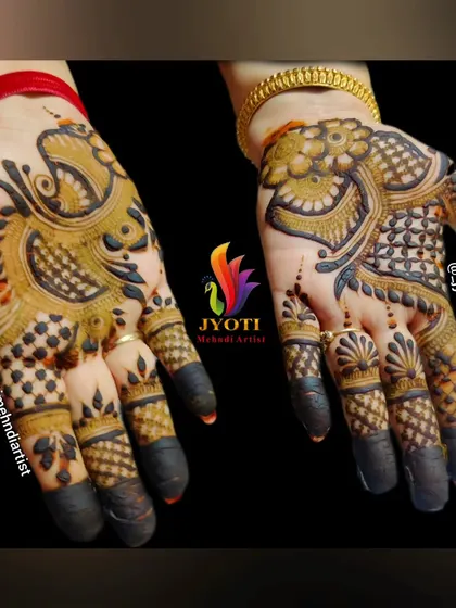 A bold Indo-Arabic design featuring a prominent peacock motif. The fingers are fully covered, and the contrast between the bold and fine lines is striking.