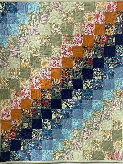 A beautiful wall piece with a "trip around the world" color-wash effect, using floral fabrics that transition from light to dark.