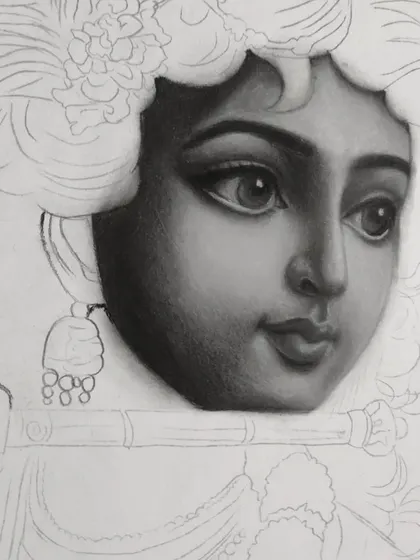 A close-up work-in-progress shot of my charcoal drawing of Krishna. This shows the careful layering and blending process I use to build up realistic skin tones and soft facial features.