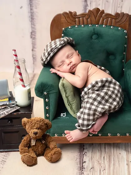 After a long day, it's time for a nap on the sofa. This pose is so sweet and shows the baby in a relaxed, natural sleeping position.