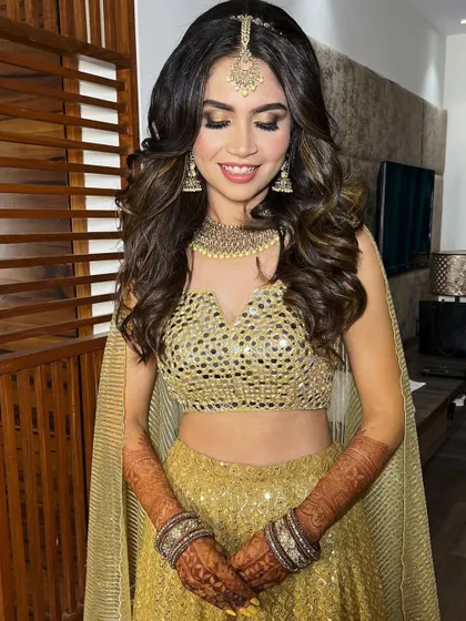 The bride looks radiant and ready for her Sangeet night. The combination of glowing skin and shimmery eyes is a personal favorite.