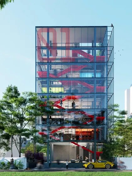 To foster collaboration in this software company office in Pune, we designed a slim, multi story atrium with a striking red staircase. The stair landings and cantilevered meeting rooms serve as nodes for interaction, connecting teams across different floors.