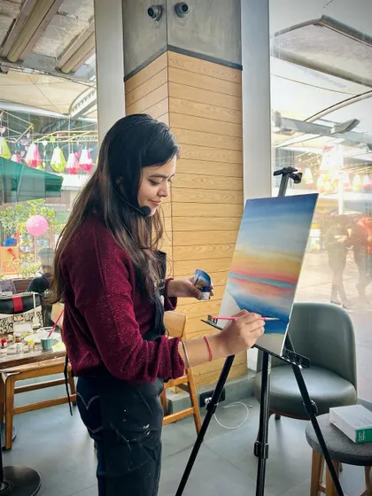 Here I am, demonstrating a technique for the sunset painting. I always paint along with the class to guide them step-by-step.