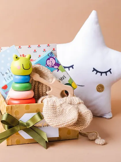 A different angle of our newborn gift hamper, showing the cute star pillow that makes a lovely addition to any nursery.