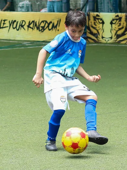 A young player showing off his ball control skills with a series of quick touches.