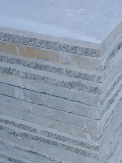 A stack of square paving stones with visible layers.