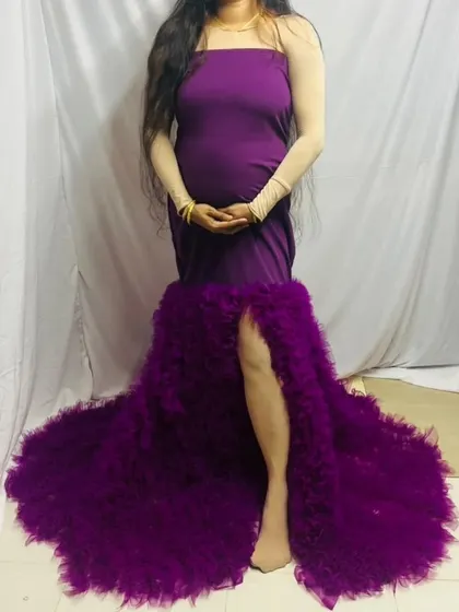 This version of the purple maternity gown shows its versatility. It can be worn without the cape for a sleek, body-hugging look with a ruffled mermaid-style train and a side slit.