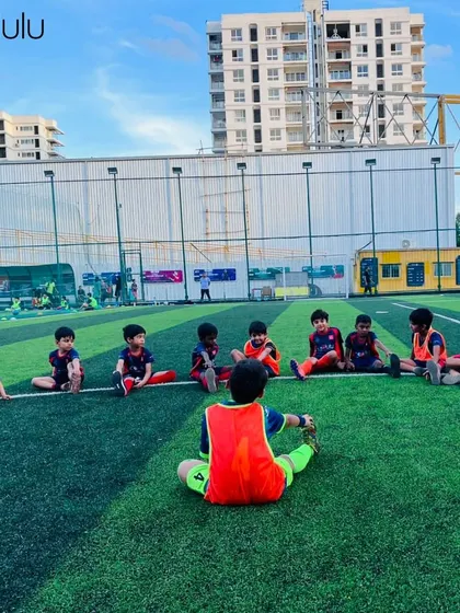 The foundation of every great player starts with the fundamentals. Our youngest football trainees learn proper stretching techniques, led by a coach on the turf.