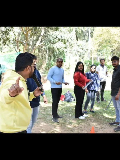 Interacting with participants during a team building exercise. I make sure to engage with smaller groups to ensure everyone feels involved.