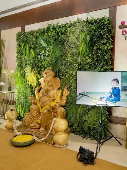 I always find ways to include what's important to your family. For this celebration, we created a special corner that blended a traditional Ganesha idol for blessings with the modern Boss Baby theme, complete with a screen showing pictures of the baby boy.