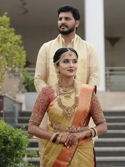 A stunning couple, Taanya and her husband. I designed his simple and elegant beige silk kurta to perfectly complement her magnificent gold and red bridal saree.