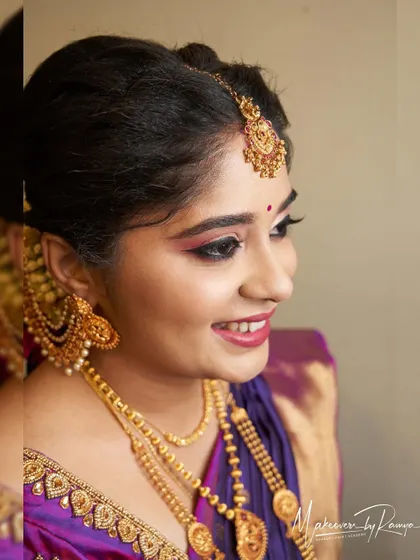 A close-up of Vidhatri's makeup, showing the soft pink and gold tones on her eyes that perfectly match her vibrant saree.