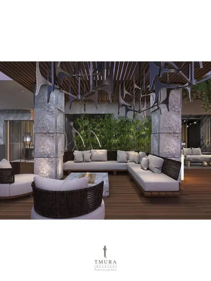 The custom outdoor furniture is arranged to encourage conversation, with a mix of sectional sofas and rounded armchairs. The sculptural element on the ceiling adds a unique artistic touch.