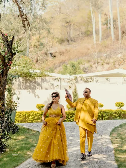 A fun, candid shot of the couple walking with swagger and style. His playful use of the fan adds a touch of personality and humor to the moment. I always encourage couples to bring props that represent them.