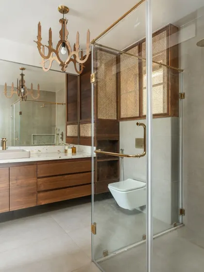 The bathroom in our penthouse features a mix of wood, cane, and terrazzo. A custom wooden chandelier adds a touch of quirky elegance.