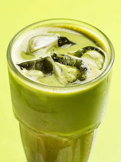 A close-up of an iced matcha drink from Mokai. The focus is on the texture and the condensation, making the drink look incredibly refreshing.