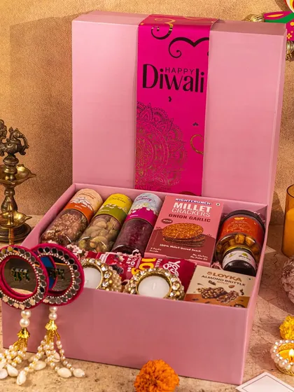 A bright and cheerful pink Diwali hamper, styled to look both modern and festive, perfect for a youthful brand.
