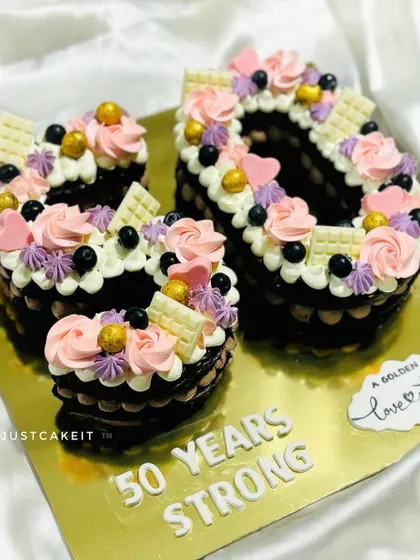 A number '50' cake for a golden anniversary. This chocolate-based cake is decorated with beautiful pink and purple buttercream flowers.