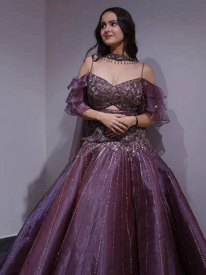 Step into the spotlight with this purple cocktail gown. The cold-shoulder design and shimmering fabric make it a trendy and glamorous choice for any evening party.