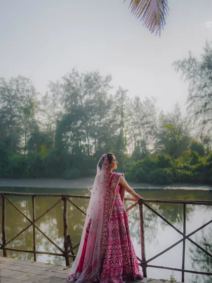A portrait of the bride from behind, looking out over the water at her destination wedding venue.