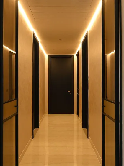 Cove lighting in this hallway provides a soft, indirect glow that makes the space feel wider and more inviting. It's an elegant solution for transitional areas.