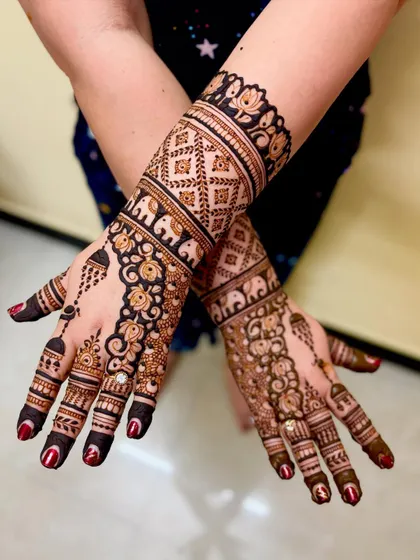A grand mehendi design for Shubha, the mother of the groom, for her son's upanayanam ceremony, personalized with family names.