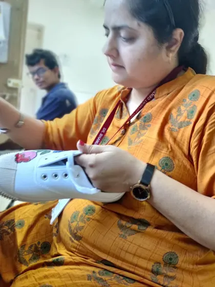 A participant fully engaged in painting her sneaker. My workshops are hands-on, providing a relaxed space where you can learn painting techniques and apply them directly to your own stuff. No experience needed.