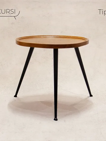 The 'Tipoy' side table. A simple yet elegant design with a solid teak top and sleek, tapered metal legs. It's a versatile piece for any corner.