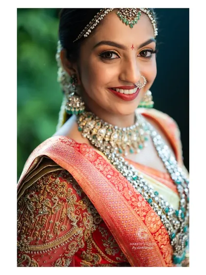 A close up of Likitha's wedding makeup, focusing on her bright smile. Creating a comfortable and long lasting lip is a crucial part of professional bridal makeup.