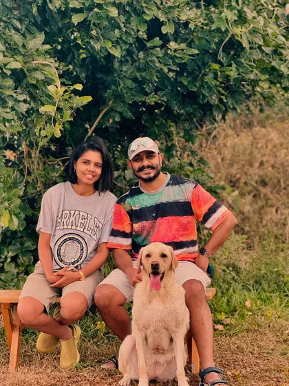 A couple and their Labrador posing for a photo on one of our park benches.