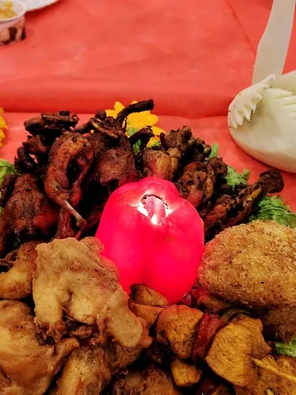 This starter platter combines the best of our fried and grilled options, including whole quail, chicken pieces, and crumbed cutlets, garnished with a carved vegetable centerpiece.