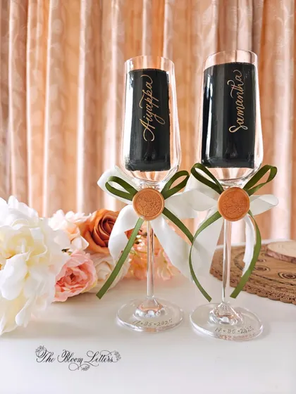 A toast to love, personalized with elegance. These champagne flutes are carefully hand-engraved with the couple's names and wedding date, creating a perfect keepsake for anniversaries and special celebrations.