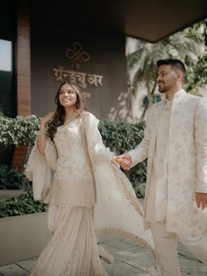 The happy couple walking hand-in-hand after their engagement ceremony. This candid shot captures the beginning of their walk together in life.