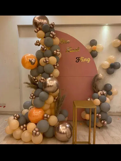 This is another example of our custom decoration services. We designed this stylish backdrop with a balloon arrangement for a 'One Last Fling' party, helping create a fun and memorable theme for the celebration.
