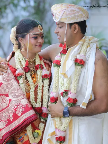 A classic portrait of the couple in their traditional wedding attire. We focus on capturing the elegance of their outfits and the happy connection between them.