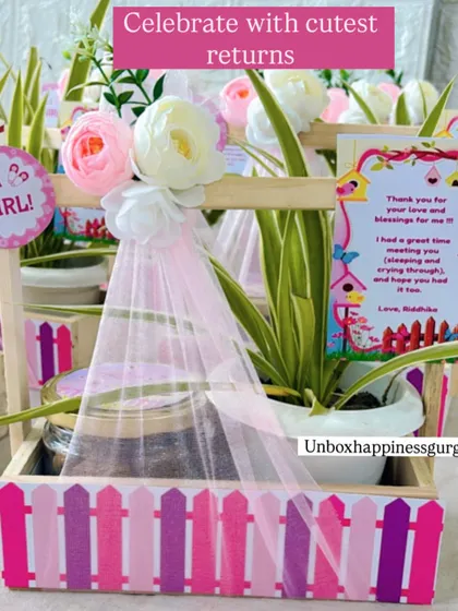 "Celebrate with cutest returns." This image showcases the charming combination of a plant and cookies in a decorated basket.