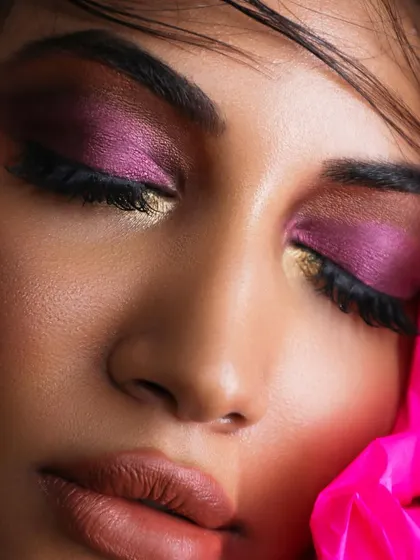 The art of blending is crucial for creative looks. Here, a vibrant magenta is seamlessly blended with gold for a stunning, colorful eye.